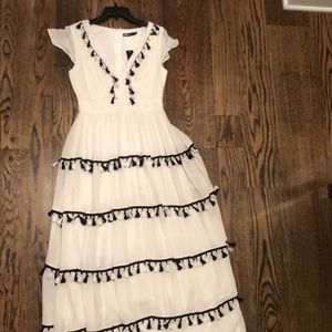 Long white dress with black and white tassels